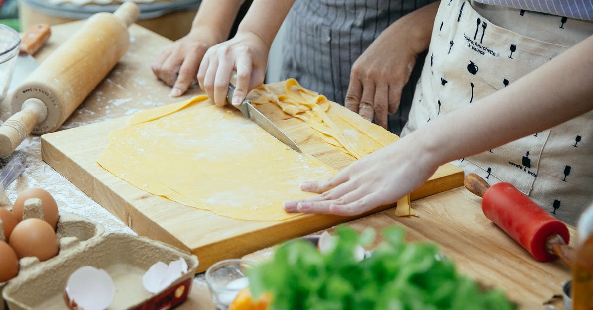 Does resting the dough for a long time reduce the need to knead the bread? - Women making homemade pasta in kitchen