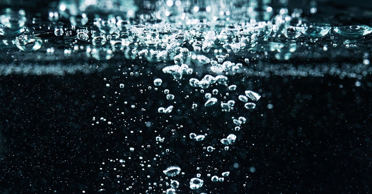 Does shaking carbonated water before use increase the carbonation? - Macro Photography of Bubbles in Water