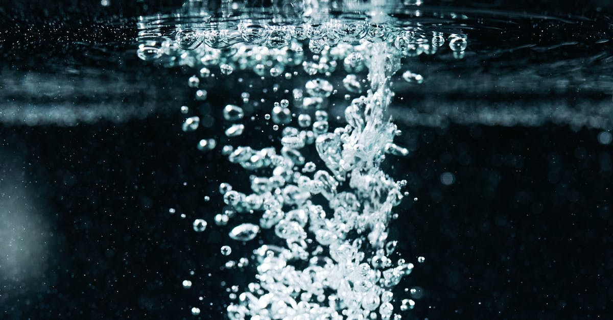 Does shaking carbonated water before use increase the carbonation? - Macro Photography of Bubbles in Water