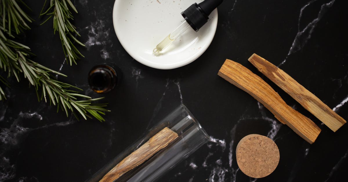 Does Simmering peppers in oil bring out more flavor? - Glass pipette with aromatic oil in plate near rosemary branches