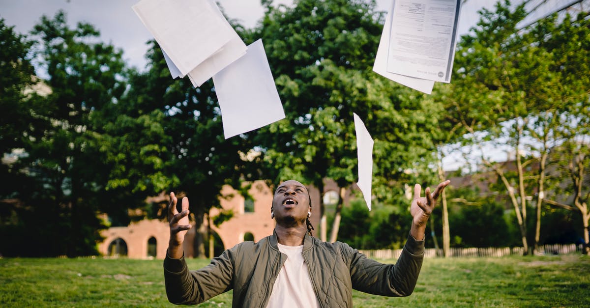 Does starch thickened custard get thinner after a few days? - Overjoyed African American graduate tossing copies of resumes in air after learning news about successfully getting job while sitting in green park with laptop