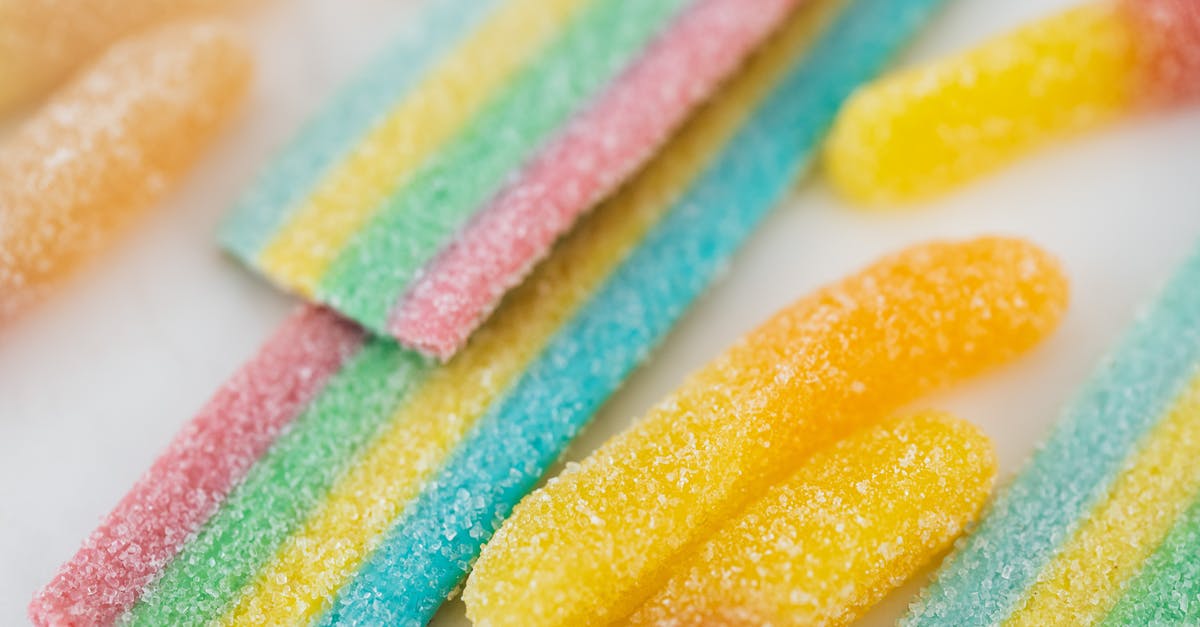 Does sugar give moisture? - Yellow and Pink Candies on White Paper