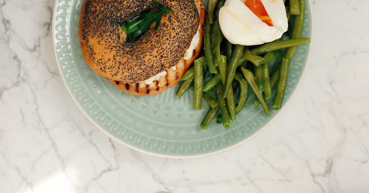 Does the strength of the barrier between egg yolk and white indicate freshness? - Ceramic plate with tasty fresh bagel and asparagus with poached egg served on white marble table in light modern kitchen at home