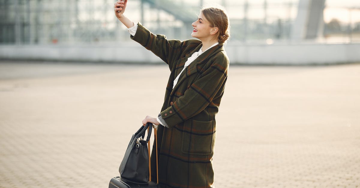 Does using a sponge in a brioche make a difference? - Stylish young woman with luggage taking selfie outside modern glass building