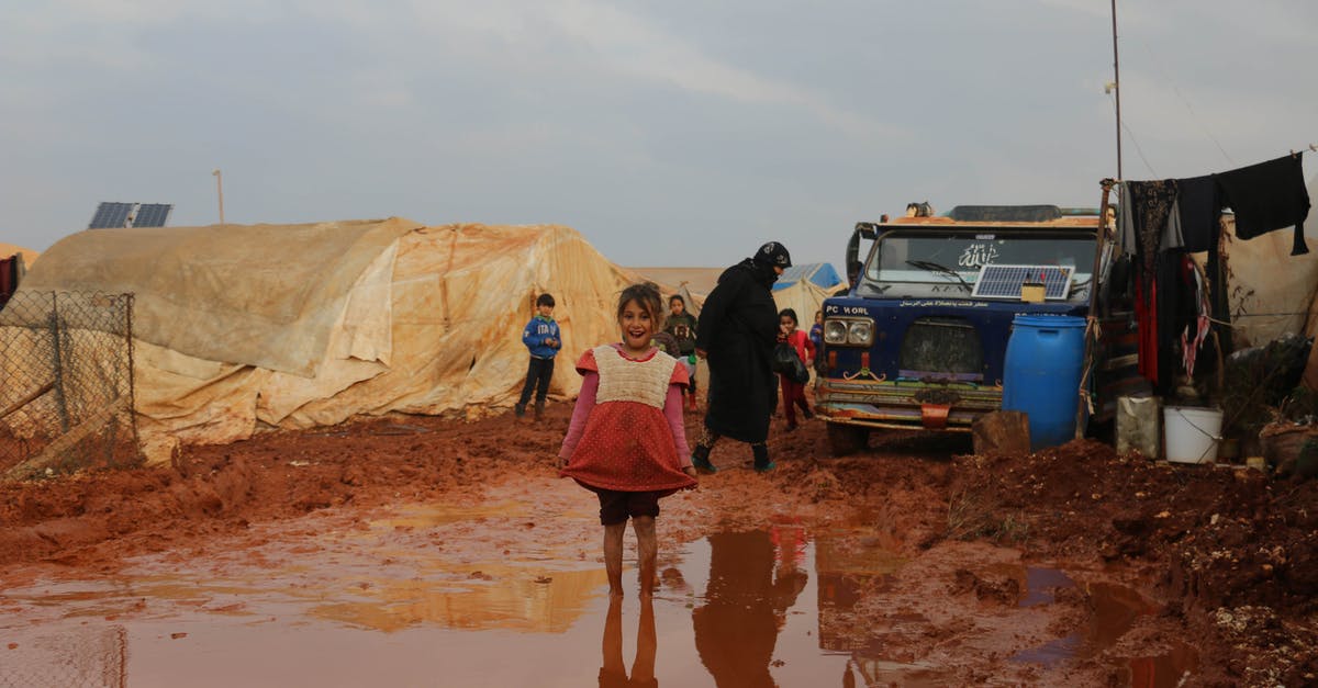 Does vinegar need to be refrigerated after being opened? - Joyful ethnic girl standing in dirty puddle