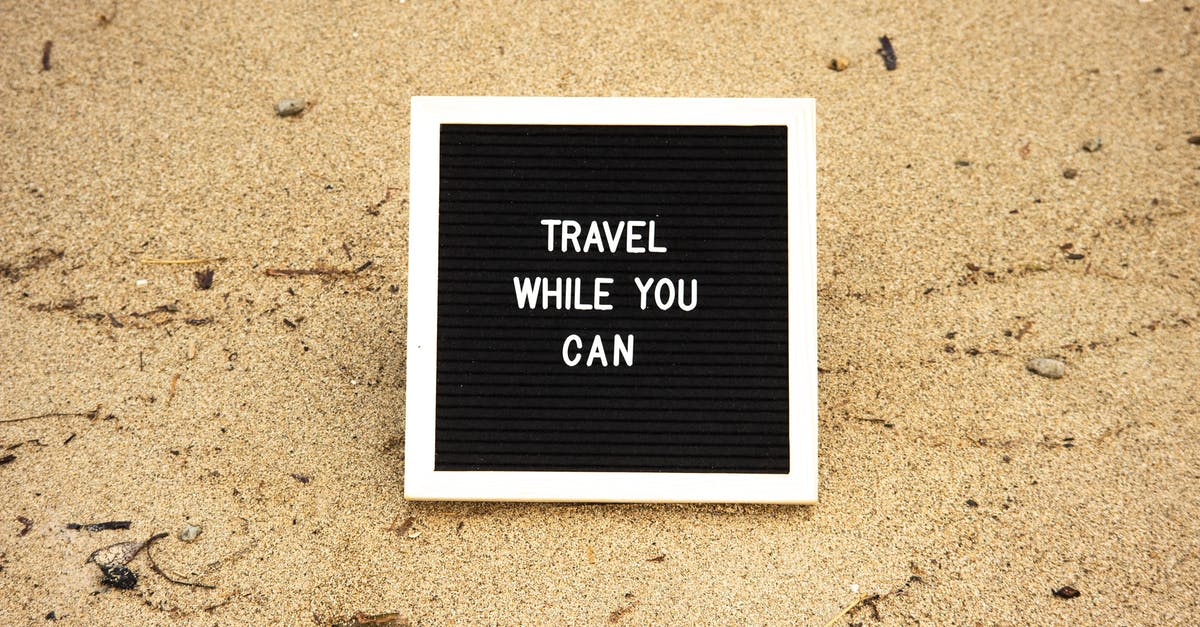 Does water "go bad" in this sense? - Board with Text 'Travel While You Can' on the Sand