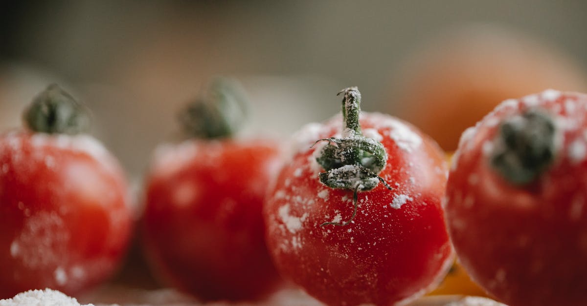 Does white whole wheat flour need to be refrigerated? - Fresh red tomatoes in flour prepared for cooking and covered with flour in kitchen in soft focus