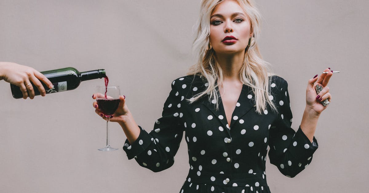 Does wine go bad or just taste bad? - Confident woman standing with wineglass and cigarette