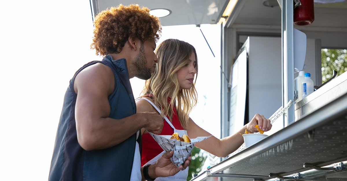 Does Worcestershire Sauce go Bad? - Multiethnic couple having lunch at street food truck