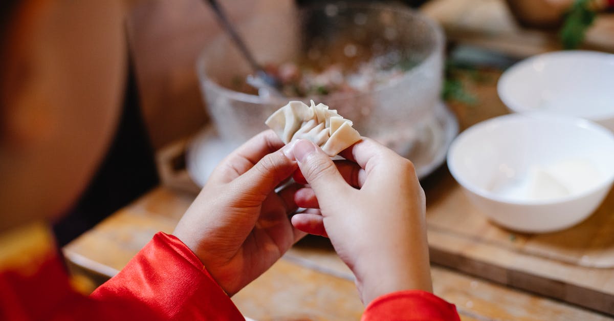 Dough for edible bowls, plates - High angle of crop anonymous boy cooking dumplings with dough and ground meat for traditional Chinese lunch