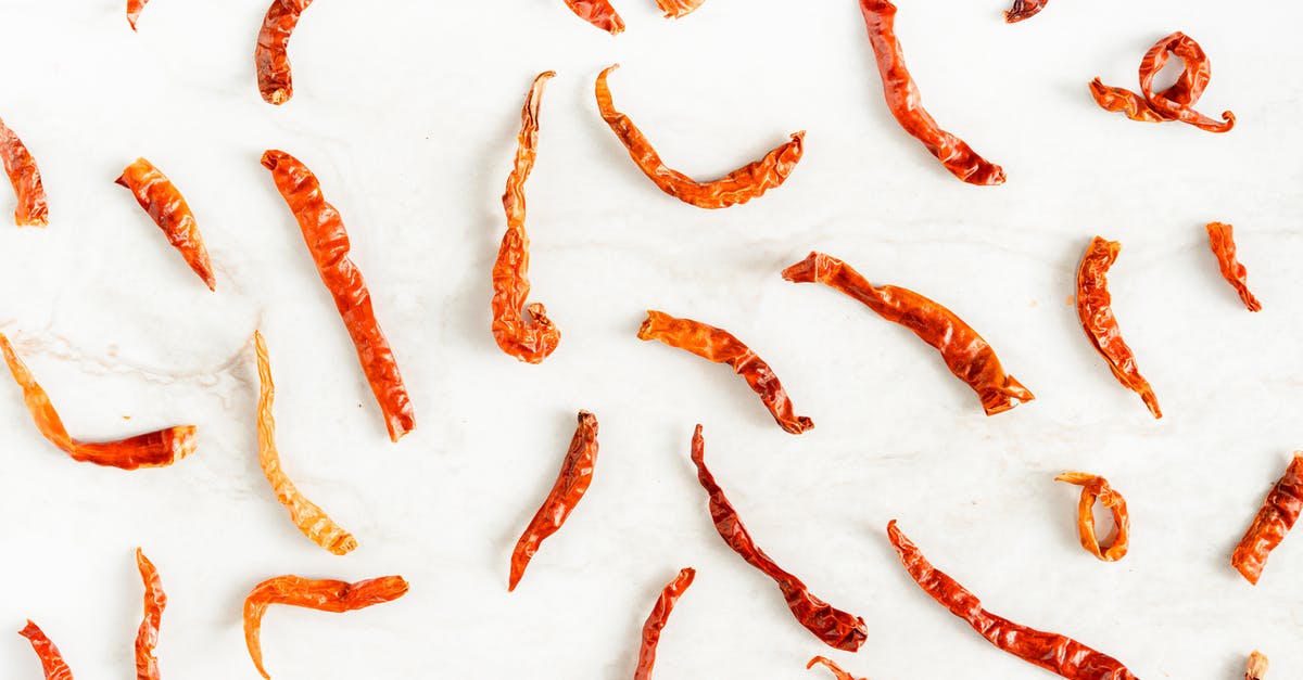 Dried Kidney beans for Chili - Scattered Dried Chili Peppers on White Surface 
