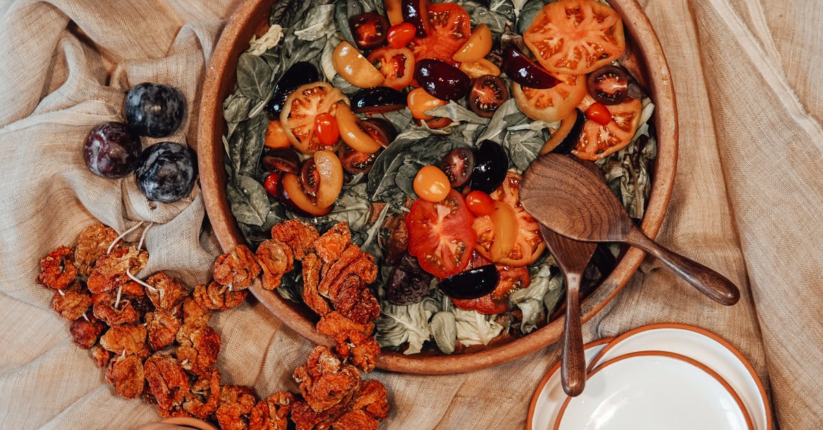 Dried tomatoes vs. dried tomatoes in oil - Sliced Fruits in Brown Wooden Bowl