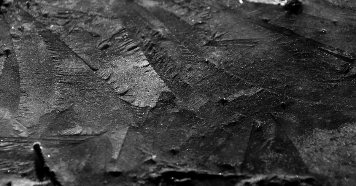 Dry and Tough Rumproast - From above black and white closeup of textured background representing geologic rock with uneven surface