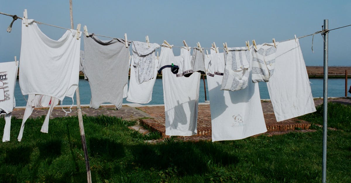 Drying fruits with a household dehydrator - Drying washed laundry hanging on clothesline between poles on grassy seashore on sunny summer weather