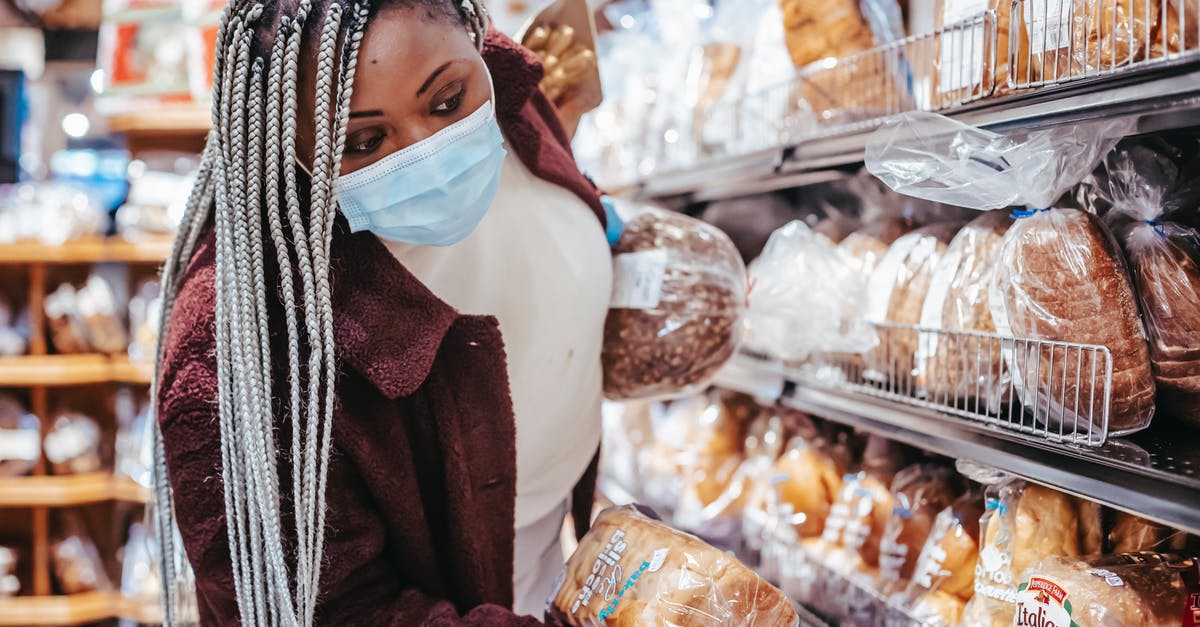 Drying store bought bread for stuffing - Black woman choosing bread in baking department