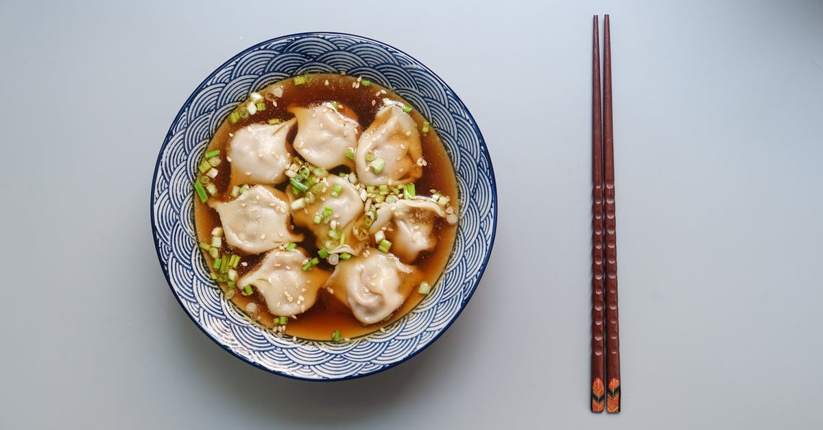 Dumplings - What happened? - Round White and Blue Ceramic Bowl With Cooked Ball Soup and Brown Wooden Chopsticks