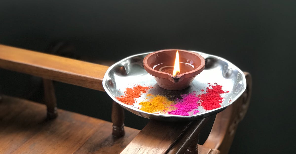 During flambé, what is the powder that is shaken into the fire to create sparks? - Candle and colorful powder on metallic plate