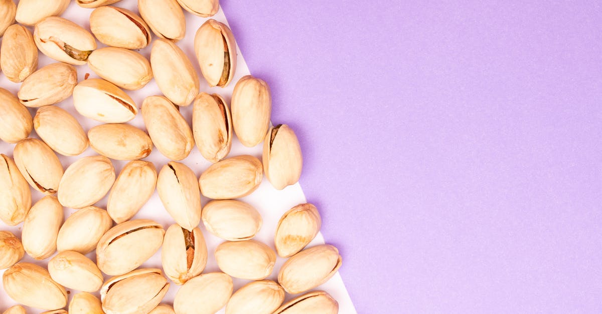 Easier way to shell out sunflower seeds - Pistachios on White Surface with Purple background