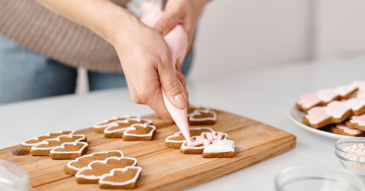 Effect of adding wet ingredients to dry when making bread? - Person Decorating a Christmas Tree Shaped Cookies