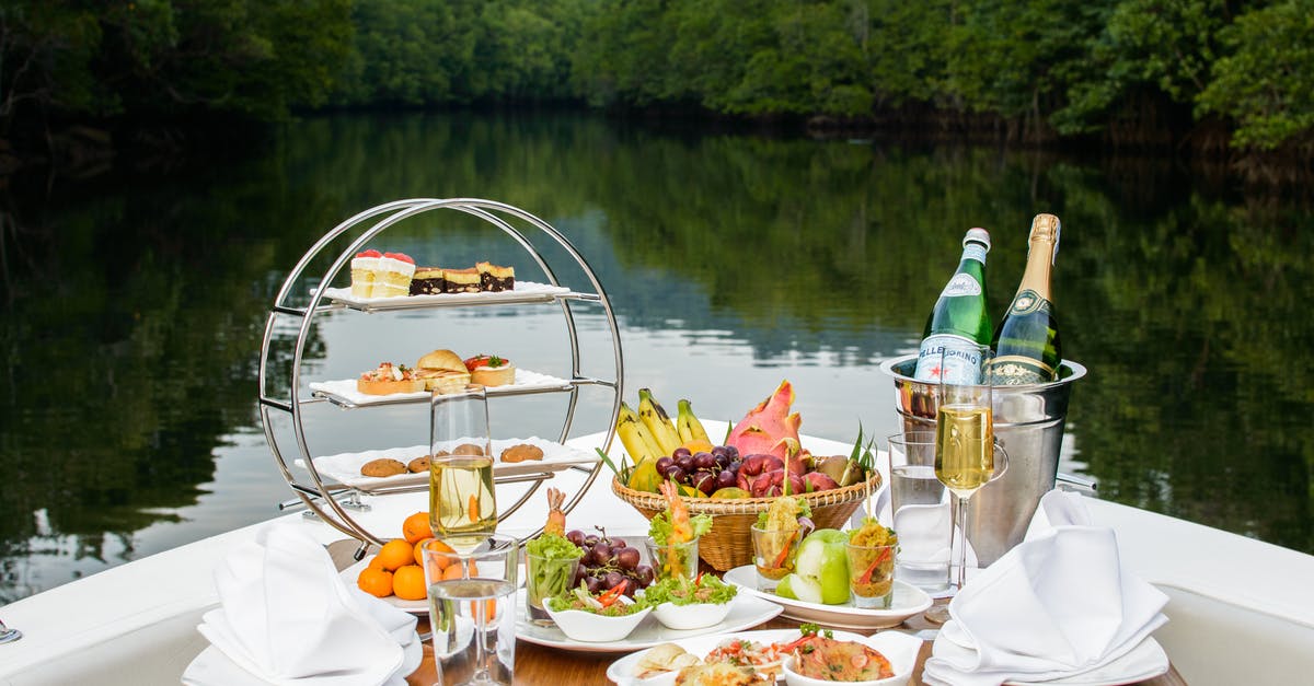 Effect of wine used for deglazing on dish - Food Photography of Food and Wine Bottles on Table Inside Boat