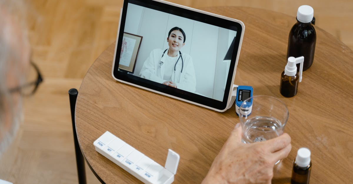 Effects of making smoothies in advance - Person Holding Black Ipad on Brown Wooden Table