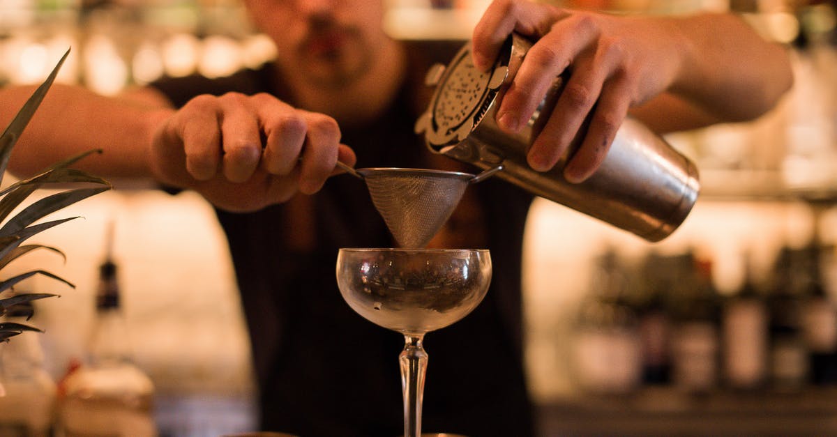 Effects of making smoothies in advance - Person Pouring Water on Clear Wine Glass