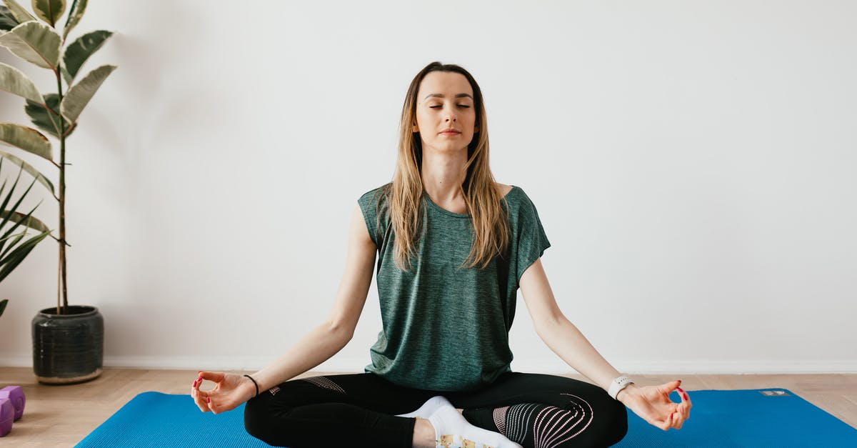 Eggnog to Spirit ratio? [closed] - Serene blond lady in sportswear sitting with crossed legs and closed eyes while practicing yoga at home near potted plants