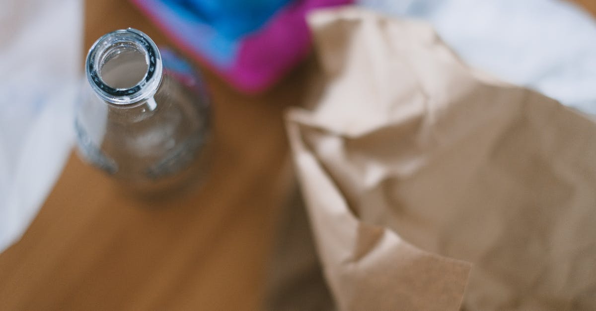 Eggs used as Binders - Top view of empty glass bottle with creased paper and egg container prepared for recycling