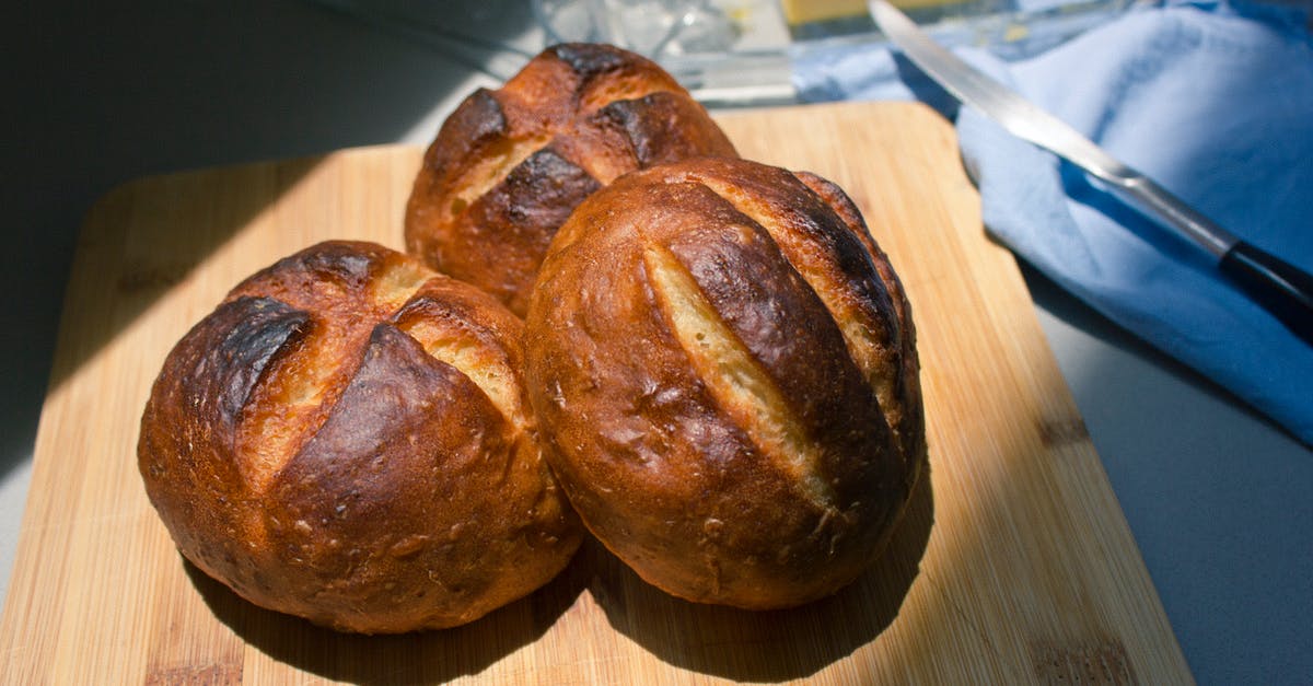 egg-wash role in having soft bread buns - Brown Bread on Wooden Board