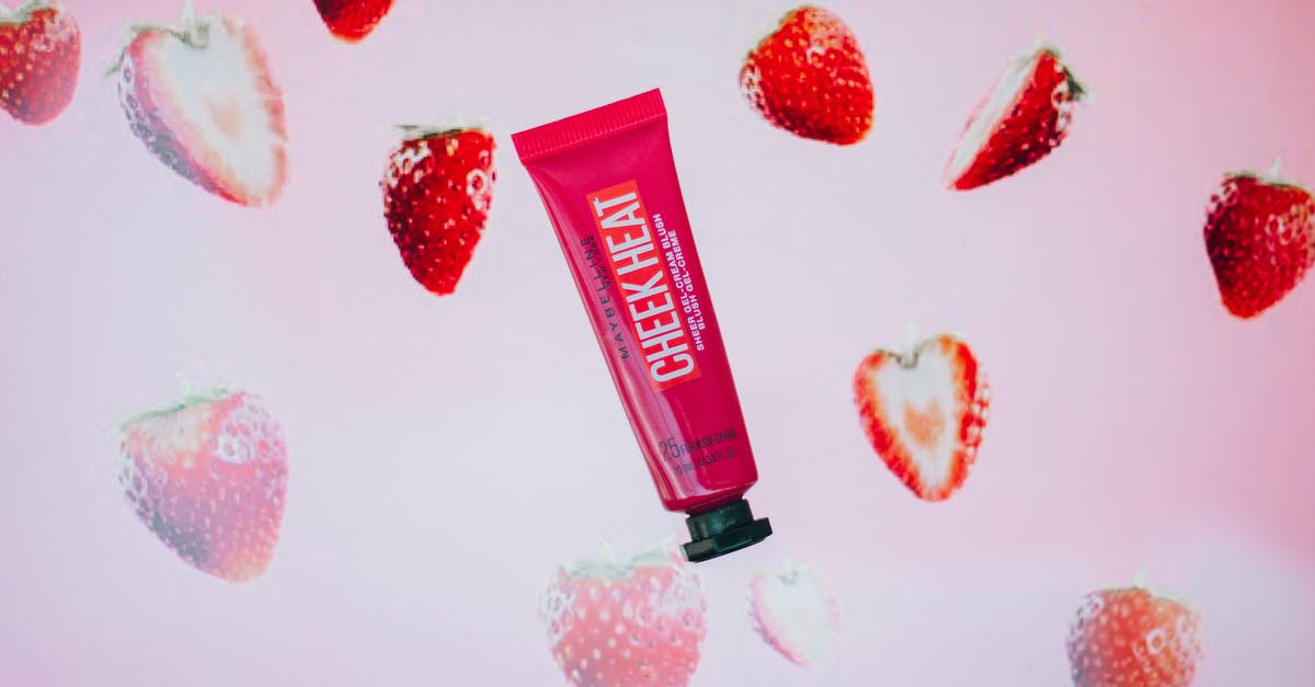 Emulating Starbucks Frappuccino Cream Base - Red tube with gel cream blush with strawberry flavor for daily beauty routine and makeup application placed on pink background