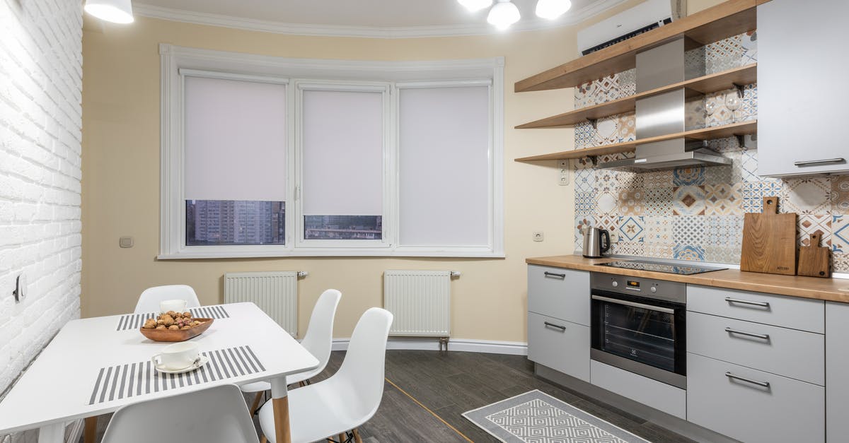 Energy usage of an oven - Kitchen interior with cabinet and shiny chandelier in flat