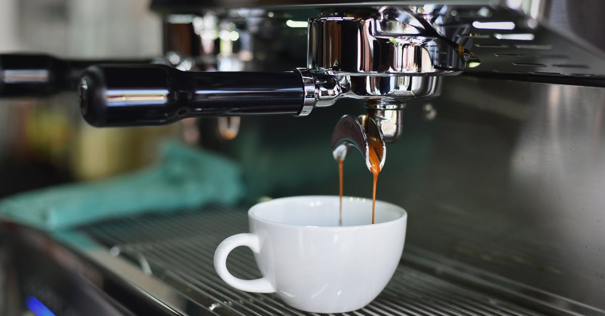 Espresso Machine coffee amount - White Ceramic Mug on Espresso Machine Filling With Brown Liquid