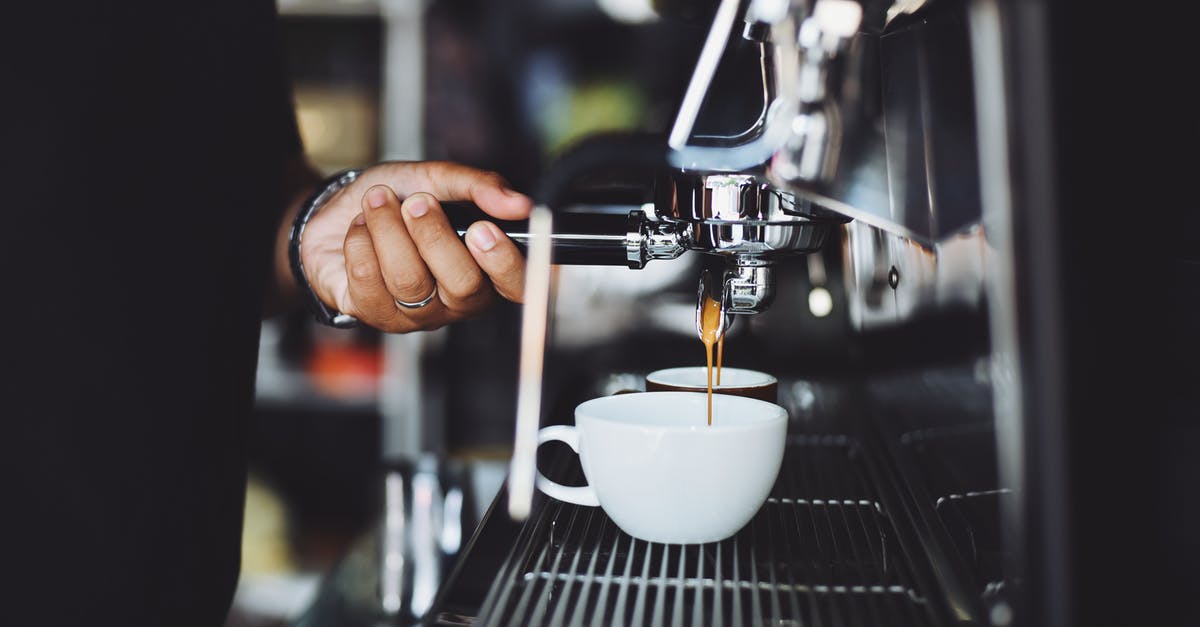 Espresso machine has to warm up halfway through pulling a shot - Close-up of Hand Holding Coffee Machine