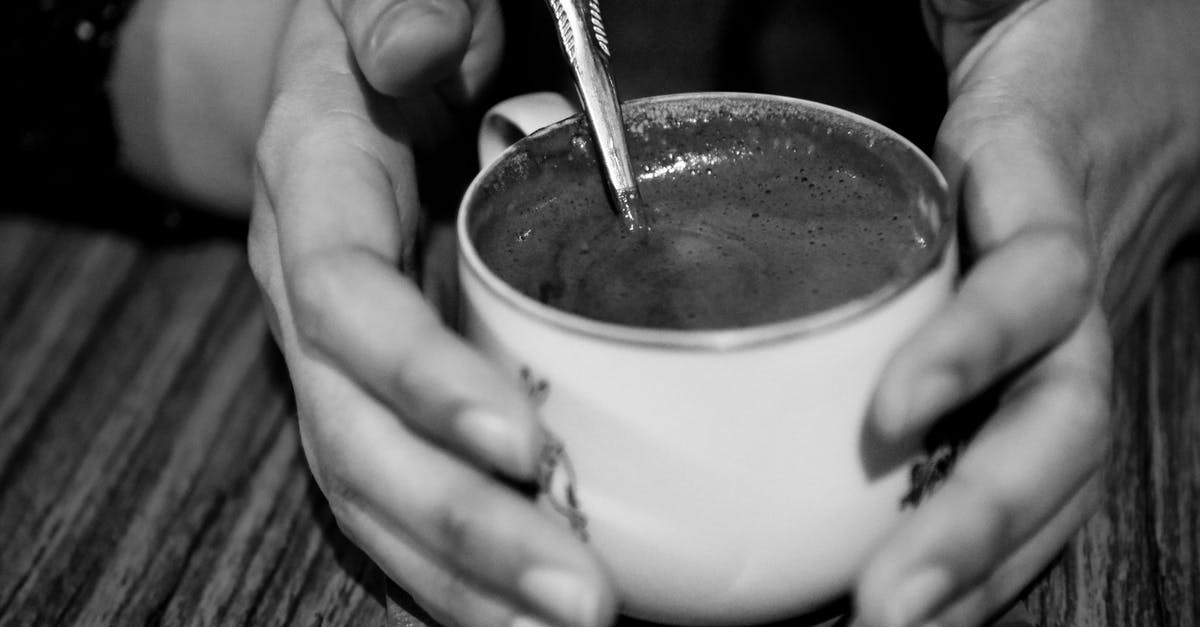 Espresso machine has to warm up halfway through pulling a shot - Person Holding Teacup Grayscale Photo