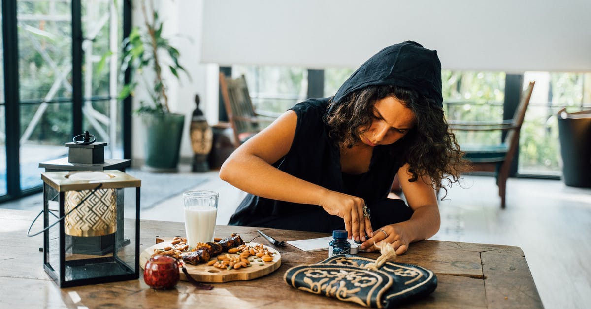 Expiration Date on Milk - A Woman in Black Hoodie Sitting at the Table Opening a Bottle of Ink