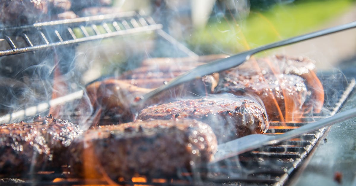 Extremely hard layer after cooking the burger on the grill - Close Photography of Grilled Meat on Griddle