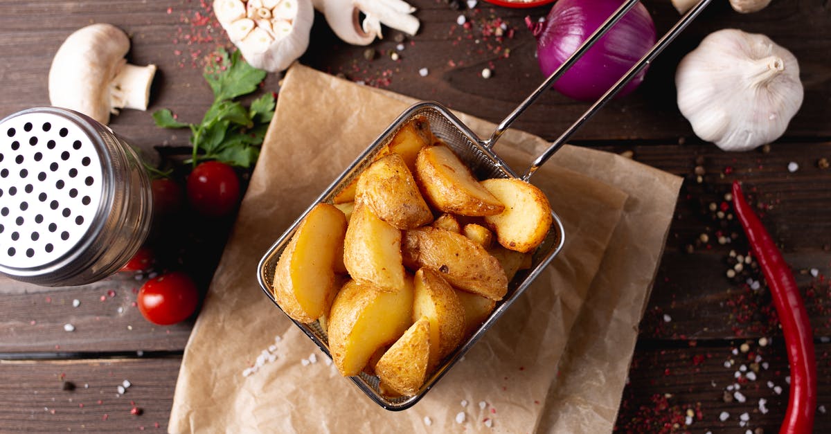 Fastest way to cook a baked potato? - Potato wedges placed on table amidst various seasonings