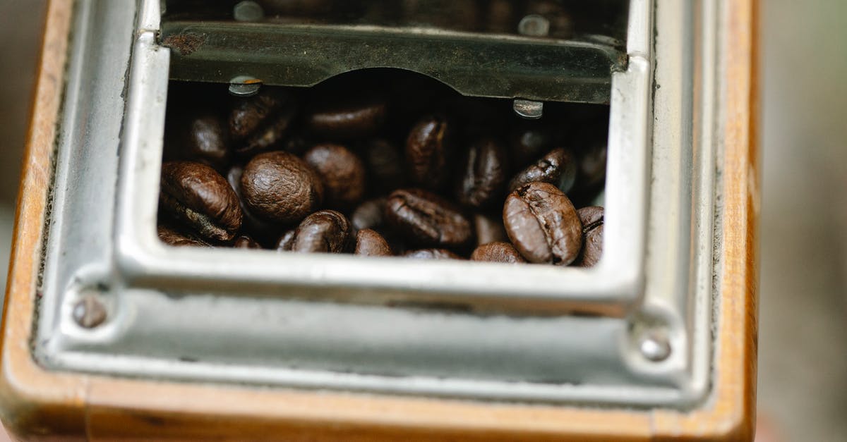 Fixing a dry cake batter - From above of dry coffee bean halves with pleasant aroma in mill box on blurred background