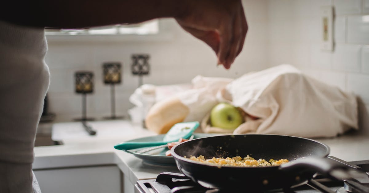 Fixing Sticky Seasoning on Cast-Iron Pan - Man Seasoning Scrambled Eggs