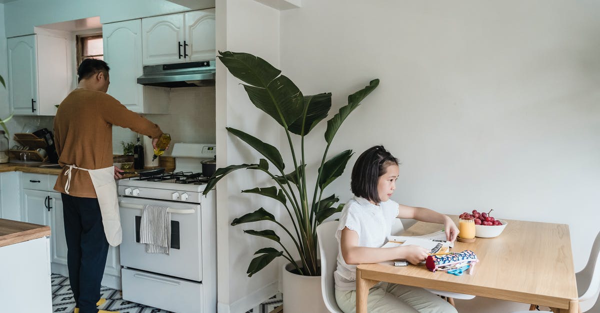 Flames into cooking area - Daughter studying on Dining Table while Father cooks on the Kitchen 