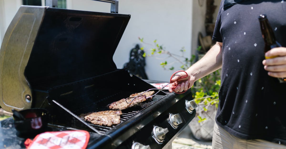 Flat griddle pan for Weber Spirit II E-320 BBQ - A Person in Black Shirt Cooking Meat while Using Tongs
