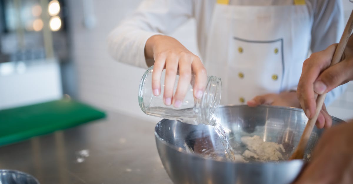 Flour and water... at which temperature? - A Hand Pouring Water on the Stainless Bowl