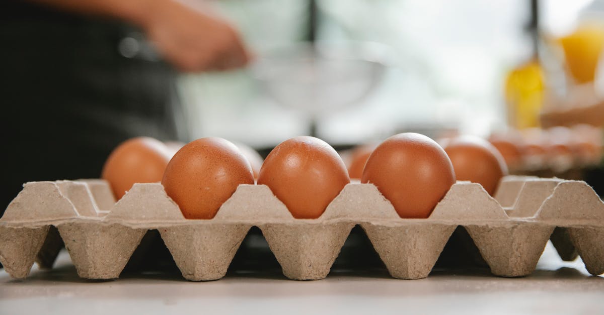 Flour protein and browning - Eggs in carton container placed on table near chef cooking food in kitchen