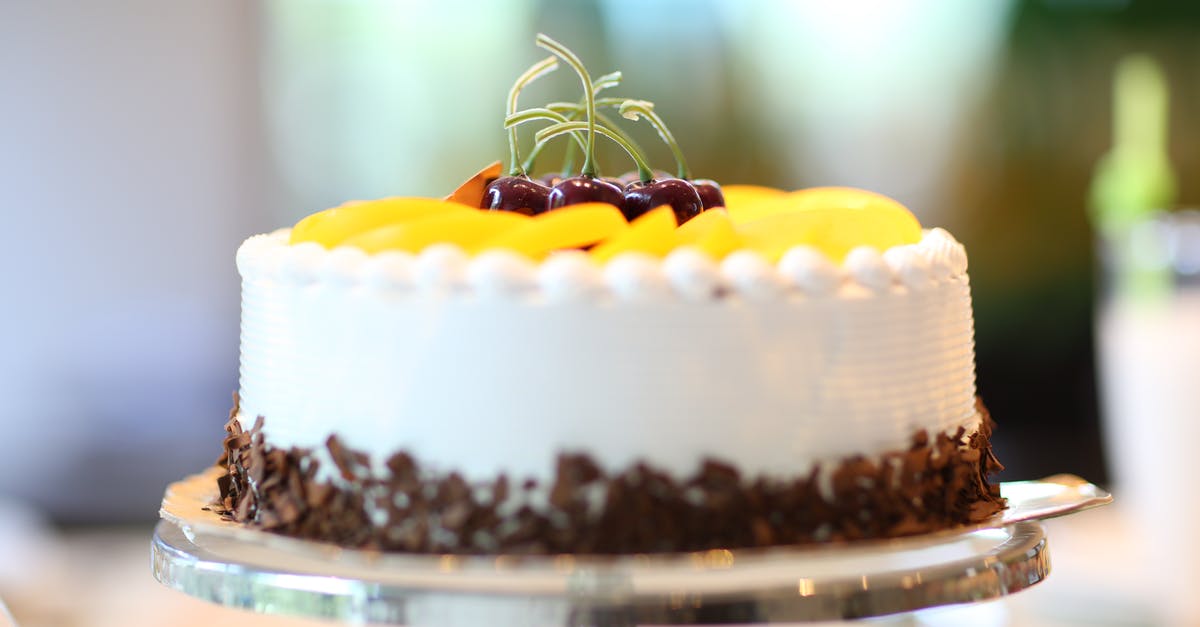 Flourless Chocolate Torte - White Round Cake Topped With Yellow Slice Fruit