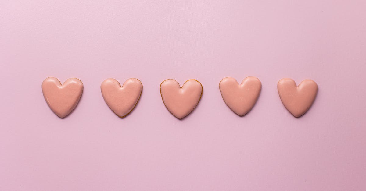 Flourless cookies form "skin" that seals in moisture - Top view of various handmade small cookies in heart shape placed on pink background next to each other