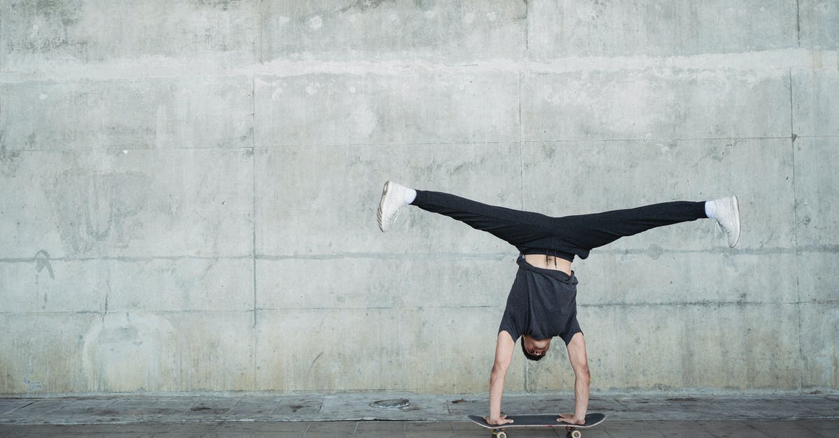 Foil over cookie sheet over broiling pan? - Anonymous guy in activewear doing handstand on skateboard while riding alone near concrete wall and pavement