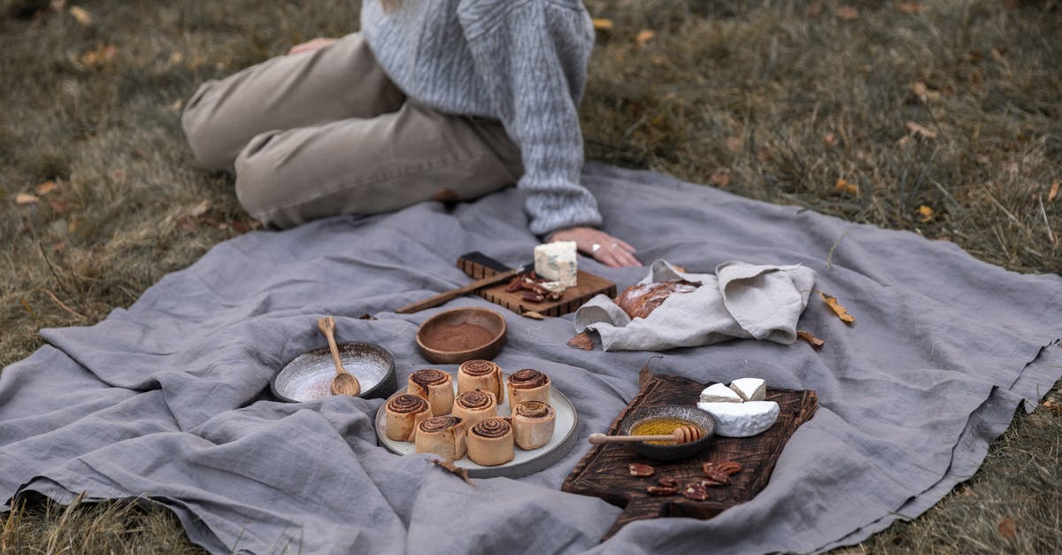 Fondue without Gruyere cheese - Person in Gray Sweater and Gray Pants Sitting on Gray Textile With Cookies on Brown Wooden