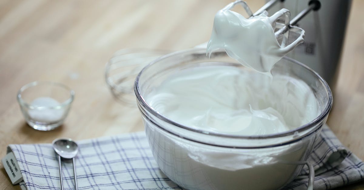 Food grade lye on counter tops - Composition on bowl with delicious whipped cream near mixer