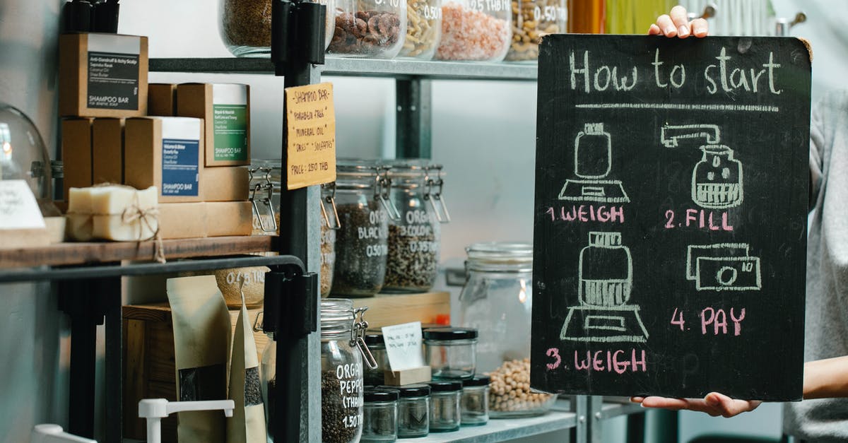 Food Pre-Packaged in Vacuum Bags - Assorted natural products and food in glass jars and paper packages on shelves in self service eco shop