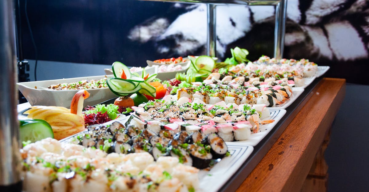 Forties dinner buffet - Sushi on White Plates on Brown Wooden Table